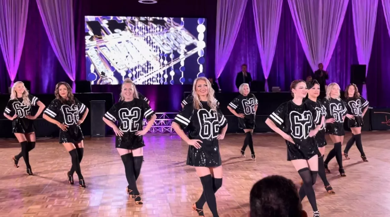 Adult Dance With Us America students performing a ballroom formation