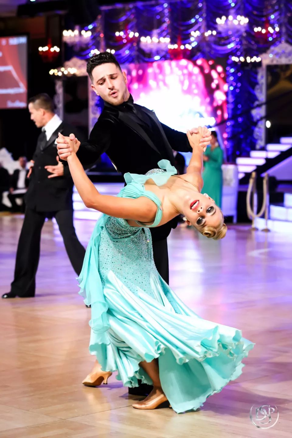 Ballroom dancers performing together at a competition