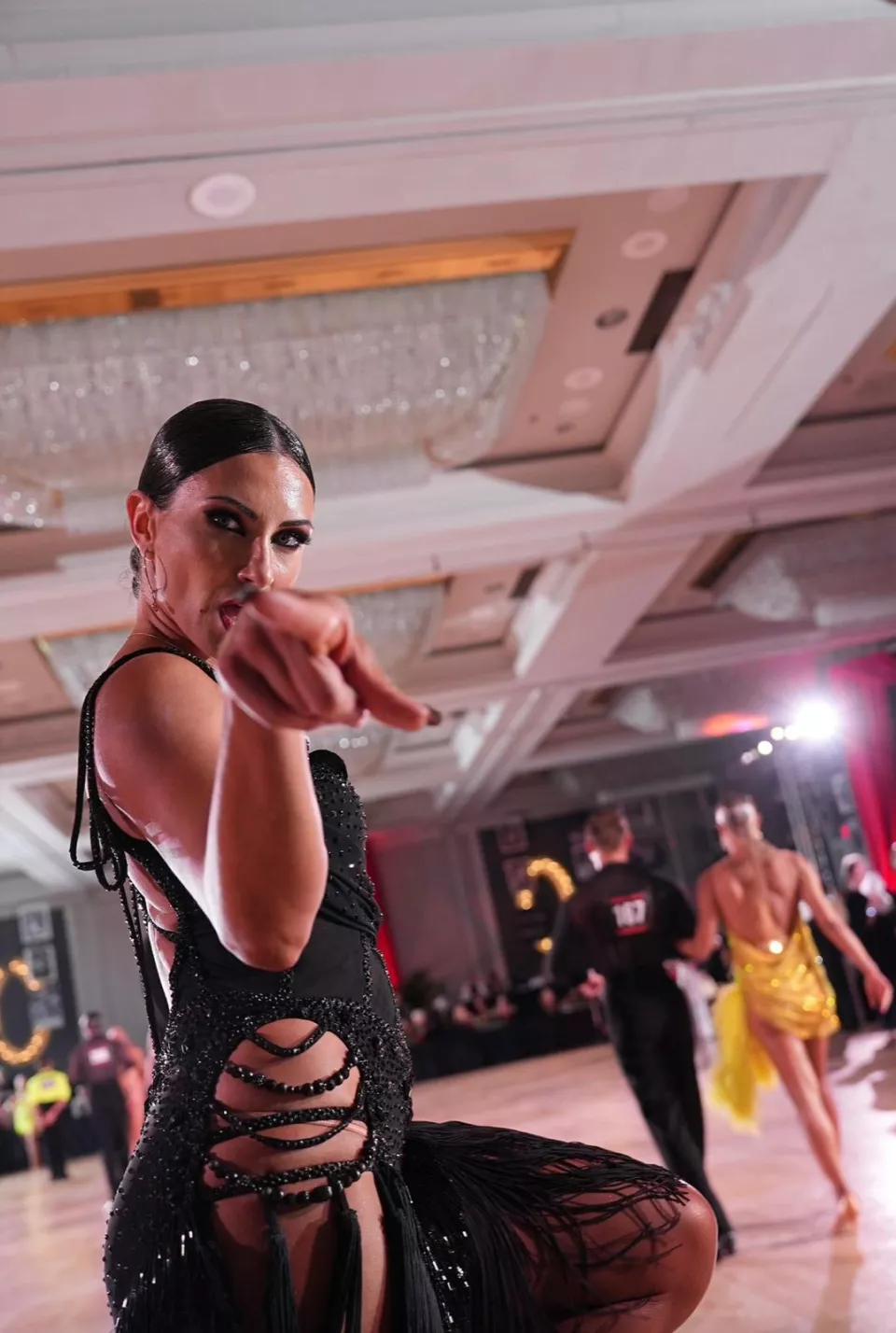 Latin dancer in a black competition costume