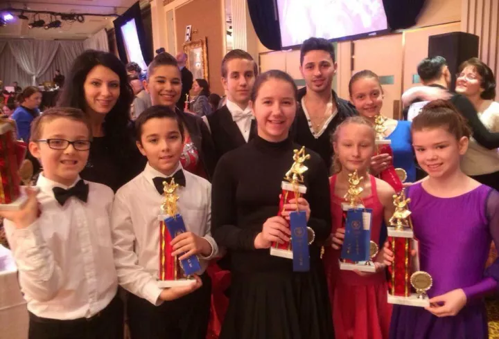 Youth dance students holding trophies